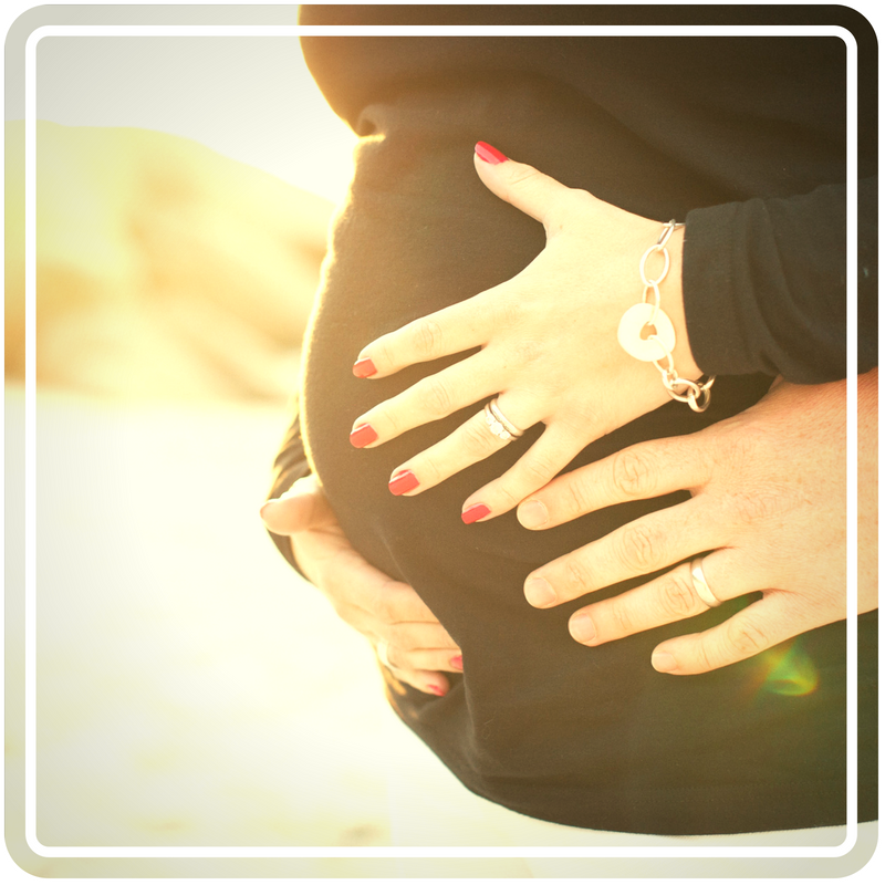 Pregnant women holding her belly